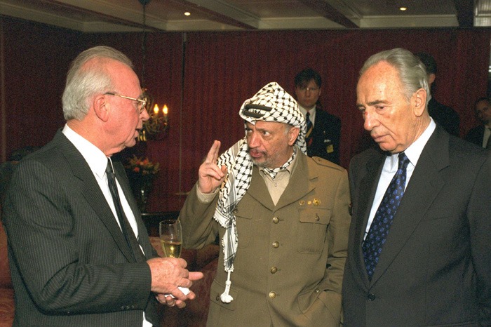 OSLO, NORWAY - DECEMBER 10: (FILE PHOTO) Palestinian leader Yasser Arafat (C) talks with Israeli Prime Minister Yitzhak Rabin (L) and Israeli Foreign Minister Shimon Peres after they were awarded the Nobel Peace Prizes December 10, 1994 in Oslo, Norway. (Photo by Yaakov Saar/GPO via Getty Images)
